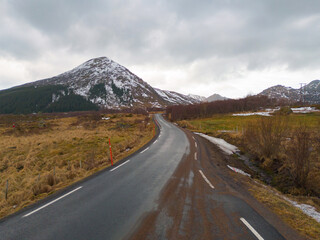 White snow mountain in Lofoten islands, Nordland county, Norway, Europe. Hills and trees, nature landscape in winter season. Winter background.