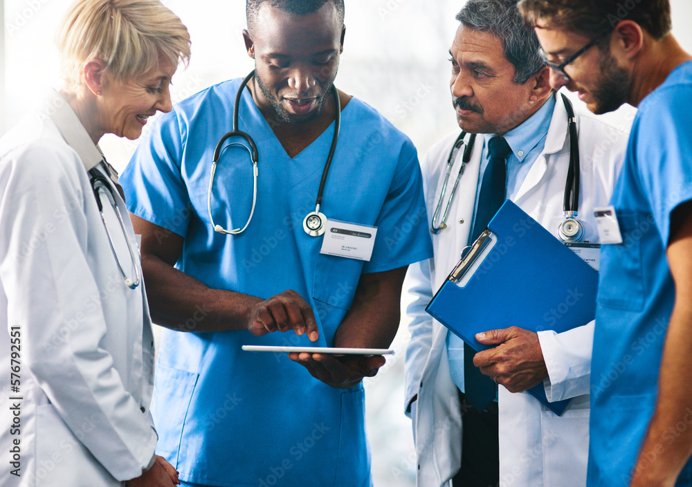 Poster making patient care smarter with smart technology. shot of a team of doctors using a digital tablet 