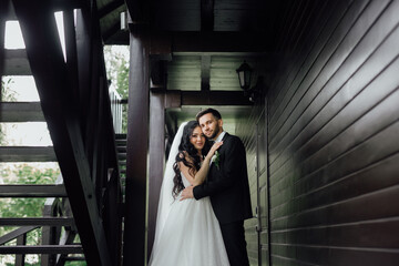 couple in love. stylish Groom in a wedding suit and the bride in a chic white dress. Wedding ceremony.