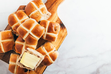 Easter Breakfast with Hot Cross Buns, served on Wooden Chopping Board. Top View