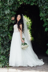 beautiful, with a large bust, the bride in a wedding dress poses for the camera. girl in white dress