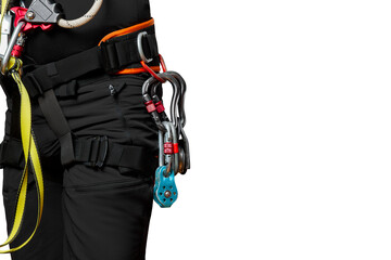High-altitude equipment, carabiners, block rollers, on a man's belt. Telecommunications, work at height, industrial mountaineering, height, insurance. Close-up. isolated