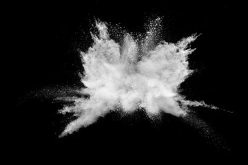 White powder explosion isolated on black background.White dust particles splash. - obrazy, fototapety, plakaty