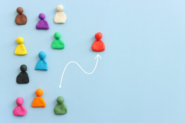 group of figures going in one direction and a unique person heading in a different direction