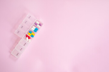 Pill box daily take a medicine, with colorful of pills, tablets, and capsules. Drugs use for...