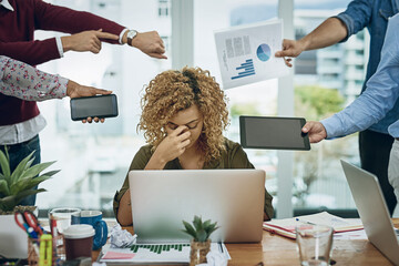 Work commitments are closing in on her. Shot of a young businesswoman looking stressed out in a...