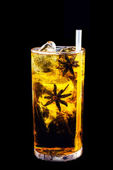 alcoholic drink with star anise, exotic drink on isolated black background