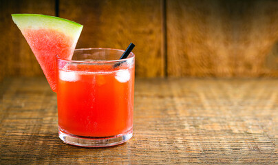 Brazilian caipirinha, cachaça drink with fruits, on wooden background. watermelon flavor, with copy space