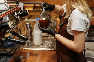 Making coffee in a coffee shop on a coffee machine