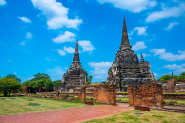 Ruins of ancient city and temples Ayutthaya, Thailand. Old kingdom of Siam. Summer day with blue sky. Famous tourist destination, spiritual place near Bangkok.