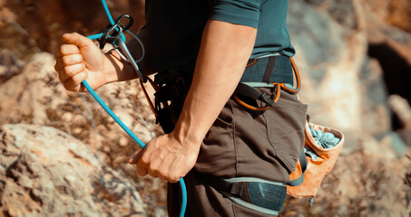 Man is engaged in extreme sports, rock climbing.