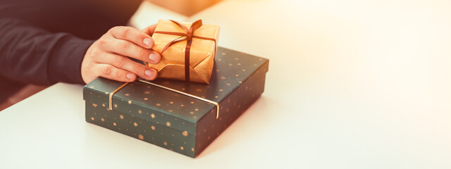 Man is preparing gifts, surprises for holidays, closeup view.