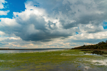 Reflection of white storm clouds in the water of the Tiligul estuary, Ukraine