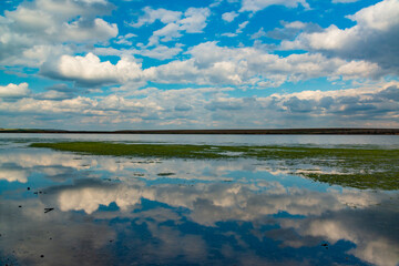Reflection of white storm clouds in the water of the Tiligul estuary, Ukraine