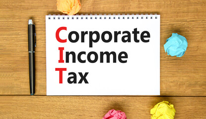 CIT corporate income tax symbol. Concept words CIT corporate income tax on white note on a beautiful wooden background. Business and CIT corporate income tax concept. Copy space.