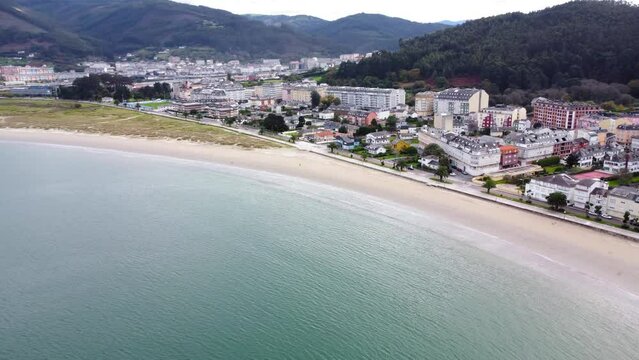 Aerial perspective of beautiful landscaped of Galicia. View of Covas city, at left is Viveiro city. Villages at the base of the mountain. Typically Galician landscape. Drone backward and right panning