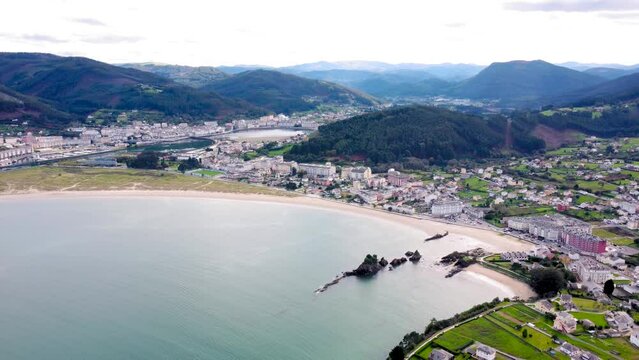 Aerial perspective of beautiful landscaped of Galicia. View of Covas city, at left is Viveiro city. Villages at the base of the mountain. Typically Galician landscape. Drone backwards