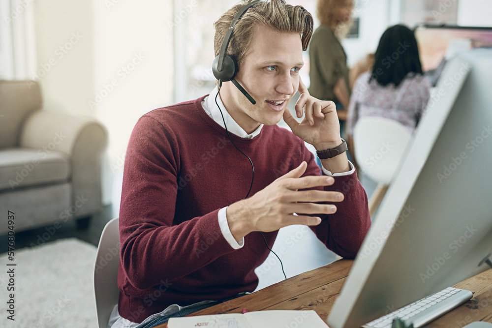 Aufkleber Delivering a high quality customer experience with every call. Shot of a young man using a headset and computer in a modern office.