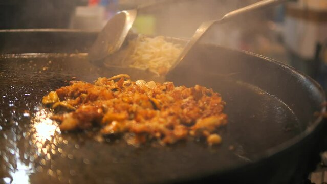 Chef Frying Minced Seafood with Soybean Sprouts at Night Market in Phuket Old Town. Local Asian Street Food. High Quality Cinematic 4K Slowmotion Thai Cuisine Footage. Thailand.