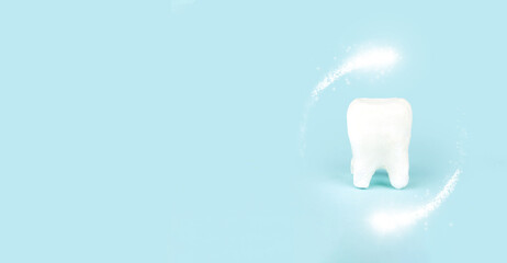 Protective vortex around tooth model of tooth on blue background. Space for text.