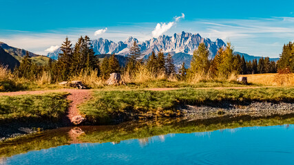 Naklejka premium Beautiful alpine autumn or indian summer landscape shot with reflections in a lake at the famous Streuboeden summit, Fieberbrunn, Tyrol, Austria