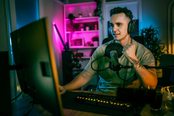 Young man male gamer playing computer game streaming video winning