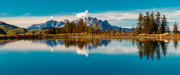 Beautiful alpine autumn or indian summer landscape shot with reflections in a lake at the famous Streuboeden summit, Fieberbrunn, Tyrol, Austria © Martin Erdniss