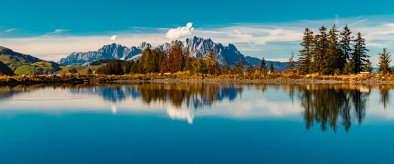 Selbstklebende Fototapeten Blue Jeans Beautiful alpine autumn or indian summer landscape shot with reflections in a lake at the famous Streuboeden summit, Fieberbrunn, Tyrol, Austria  © Martin Erdniss