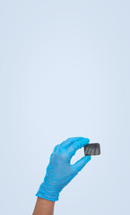 Woman hand holding x-ray of tooth on pastel blue background. Dentist stomatology medical concept. Training oral hygiene.