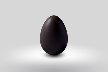 black chocolate Easter egg on a white floor