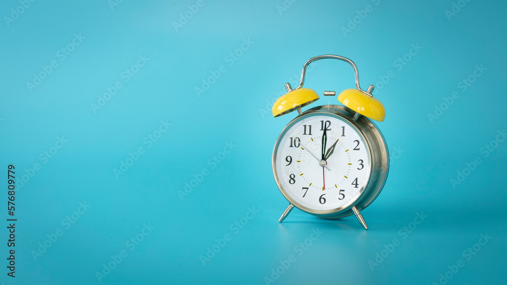 Wall mural Retro silver alarm clock.  1:00, am, pm. Blue background.