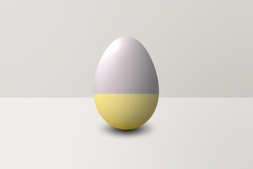 bicolor yellow and gray Easter egg in front of a white wall and on a white floor