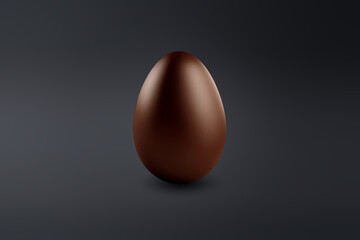 milk chocolate Easter egg on a dark floor