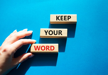Keep your word symbol. Wooden blocks with words Keep your word. Beautiful blue background. Businessman hand. Business and Keep your word concept. Copy space.