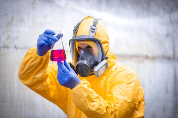 Obraz premium Chemical testing laboratory. Worker in special equipment and gas mask testing quality.
