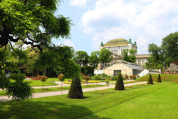 Lush plants in botanical garden, in Zagreb, Croatia. Historical archive building in the background.