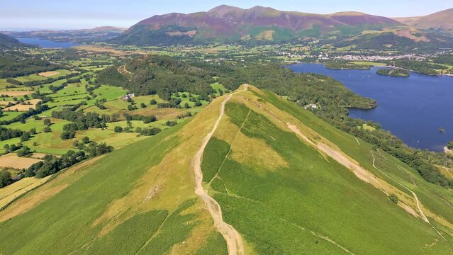 Aerial view along a mountain ridge next to a lake (Catbells, Lake District, England)