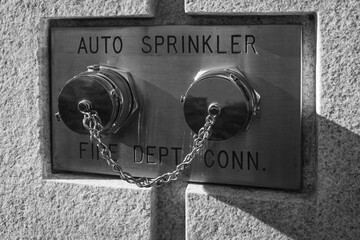 Auto sprinkler standpipe connector. Fire department connection outside of a building on a wall for Sprinkler Systems - obrazy, fototapety, plakaty