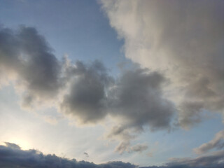 Naklejka na ściany i meble Sky with clouds being illuminated at sunset
