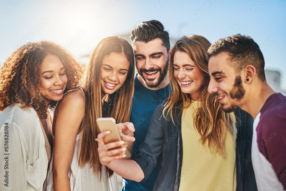 Poster check out this new app. shot of young friends using a smartphone outside.