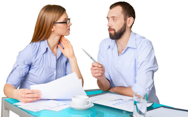 Business couple working with papers sitting at desk