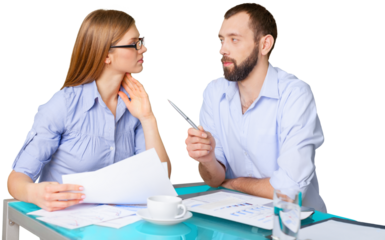 Business couple working with papers sitting at desk