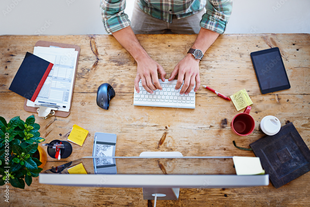 Poster he has everything he needs at his disposal. high angle shot of a designer sitting at a desk working 