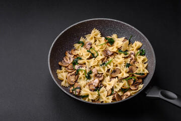 Delicious farfalle pasta with mushrooms, cheese and spinach with spices