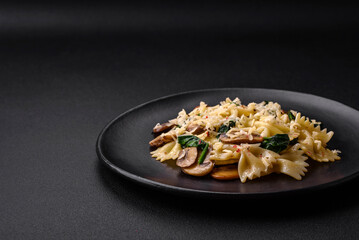 Delicious farfalle pasta with mushrooms, cheese and spinach with spices