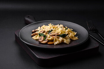 Delicious farfalle pasta with mushrooms, cheese and spinach with spices
