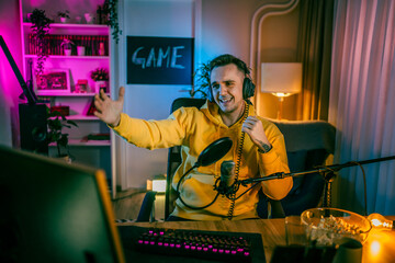 Young man male gamer playing computer game streaming video losing