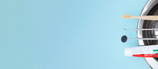 Basic dentist tools , toothbrush, toothpaste and Tooth model on blue Dental background.