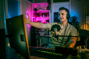 Young man male gamer playing computer game streaming video losing