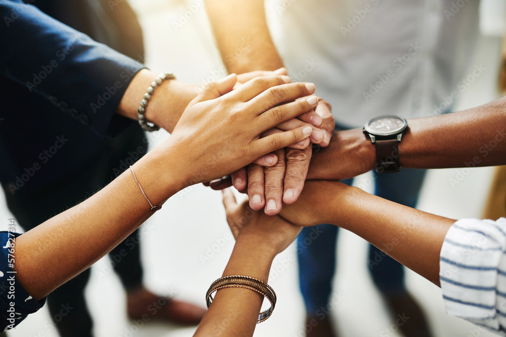 Poster together, anything is possible. closeup shot of a group of unrecognizable businesspeople joining the